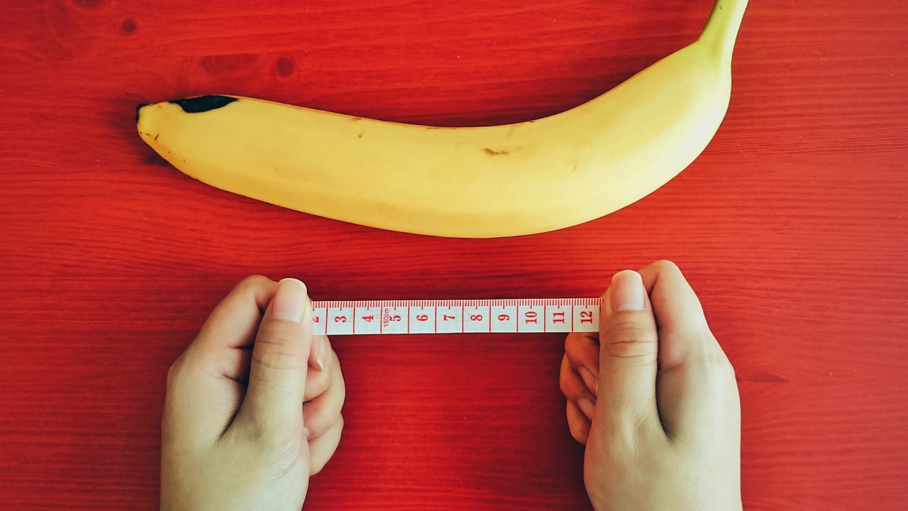 Measuring a Banana on a Sharp Red Table.