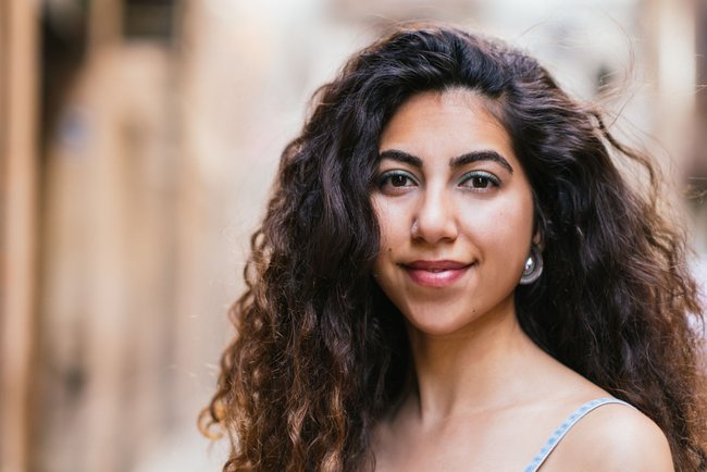 horizontal portrait of an attractive turkish woman dressing denim dress and looking at camera horizontal portrait of an attractive turkish woman dressing denim dress and looking at camera
