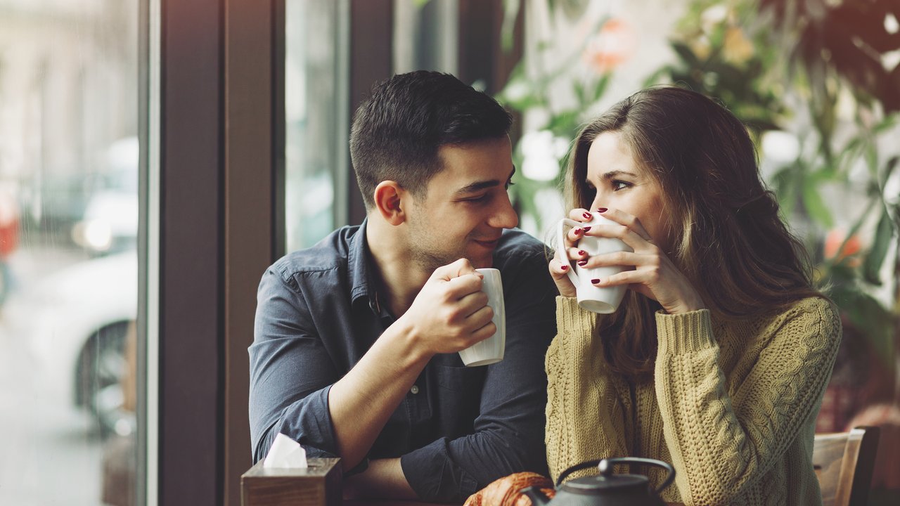 Couple in love drinking coffee and have fun in coffee shop. Love concepts. Vintage effect style picture