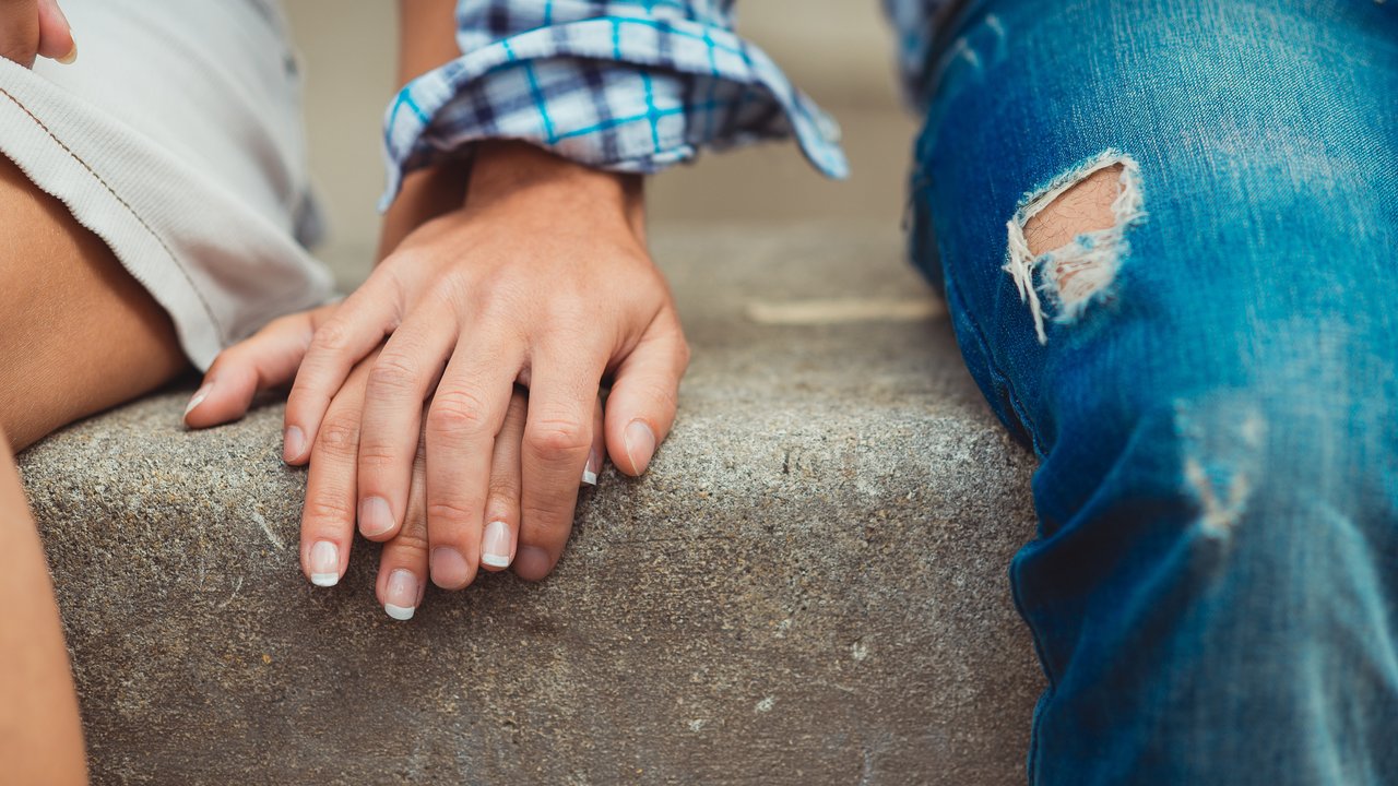A young couple in love touched hands on the first date
