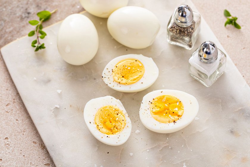 Hard boiled eggs peeled and cut in half with salt and pepper Hard boiled eggs peeled and cut in half with salt and pepper