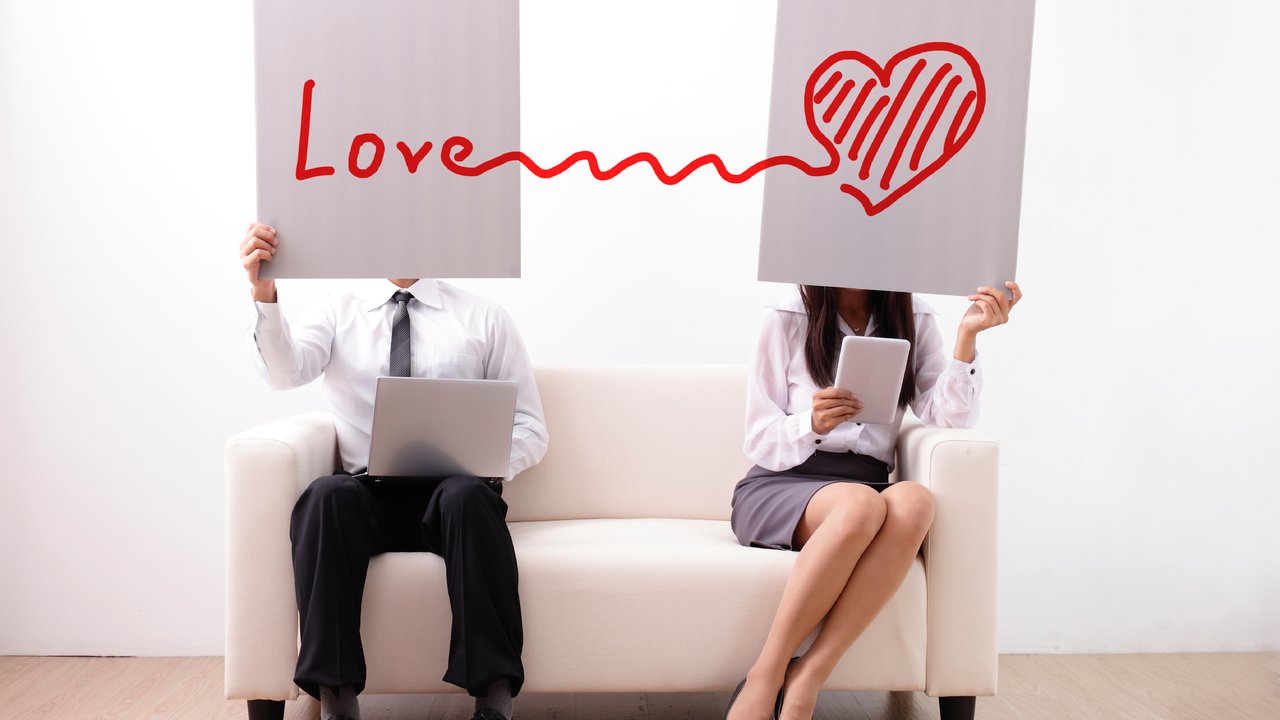 Find ture love on internet - man and woman using computer and digital tablet on sofa