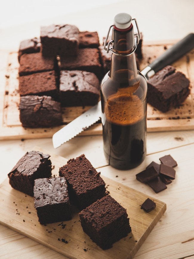 Chocolate brownie with bottle of beer on a table Chocolate brownie with bottle of beer on a table