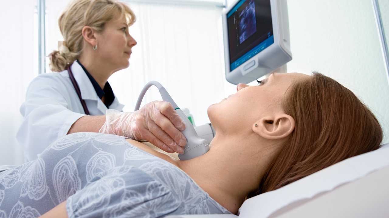 woman getting ultrasound of a thyroid from doctorPlease see similar images here: