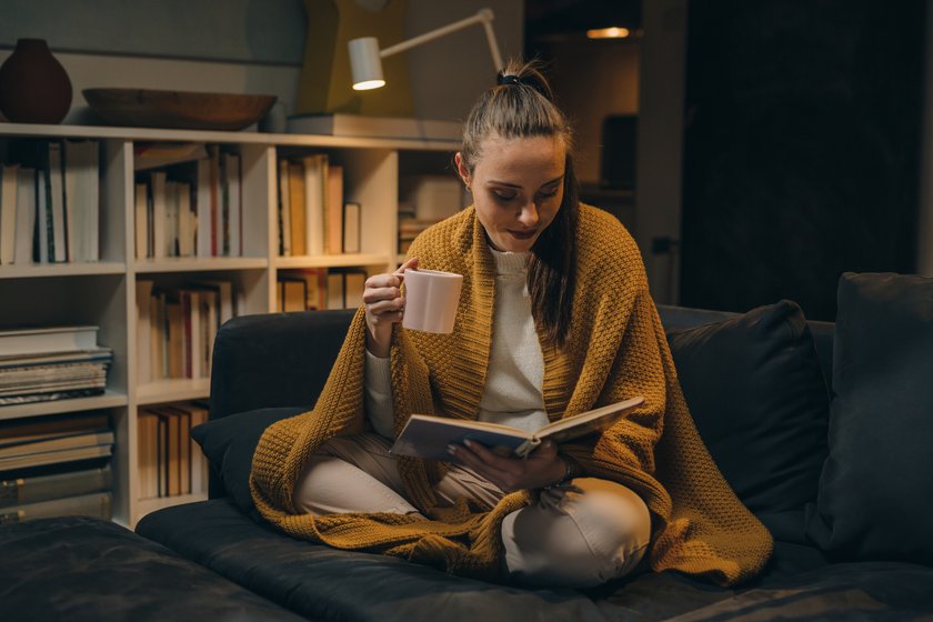 woman reading book and drinking coffee or tea at home woman reading book and drinking coffee or tea at home