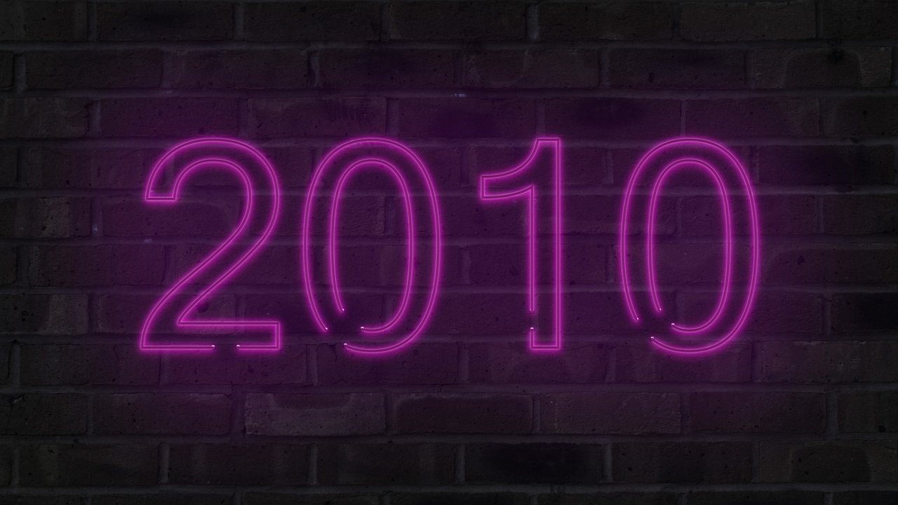 Purple 2010 neon sign on a brick wall