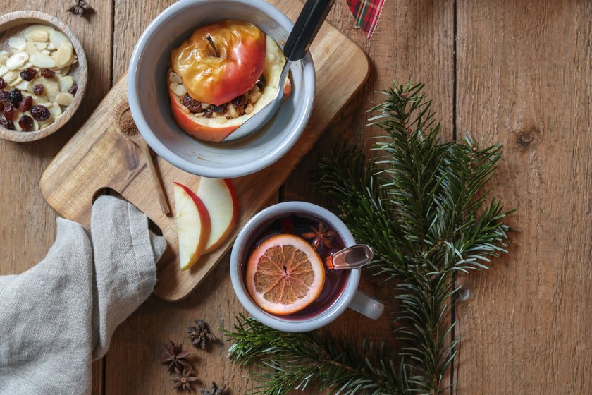 Christmas baked apple Bratapfel Winter Dessert in rustic kitchen with mulled wine Christmas baked apple Bratapfel Winter Dessert in rustic kitchen with mulled wine