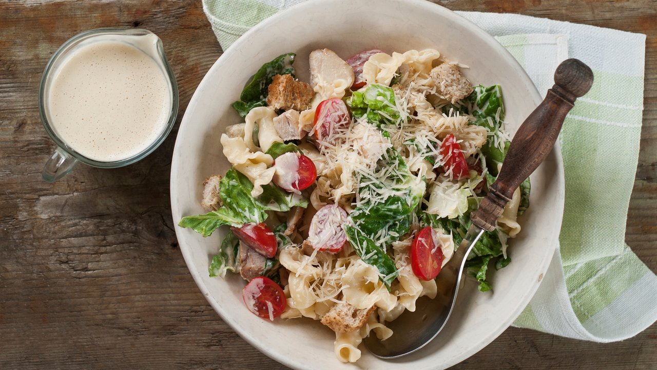 Pasta salad with chicken, tomato, cheese and sauce, selective focus