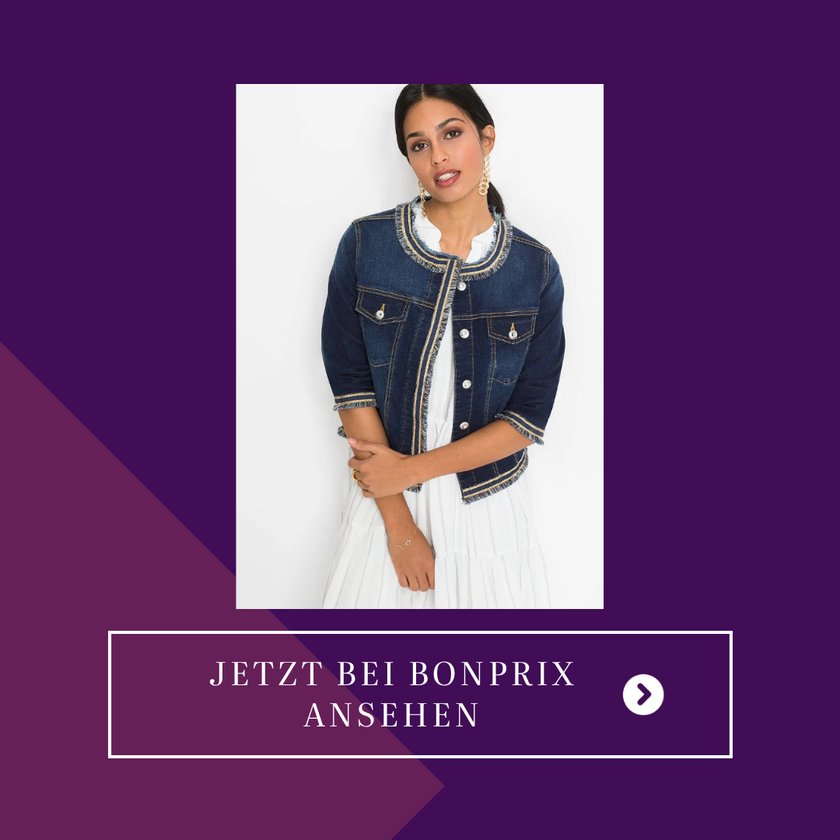 Eine&#x20;Frau&#x20;tr&#x00E4;gt&#x20;eine&#x20;ausgefallene&#x20;Jeansjacke&#x20;mit&#x20;Fransen