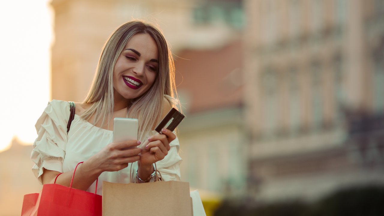 Beautiful Woman texting while shopping