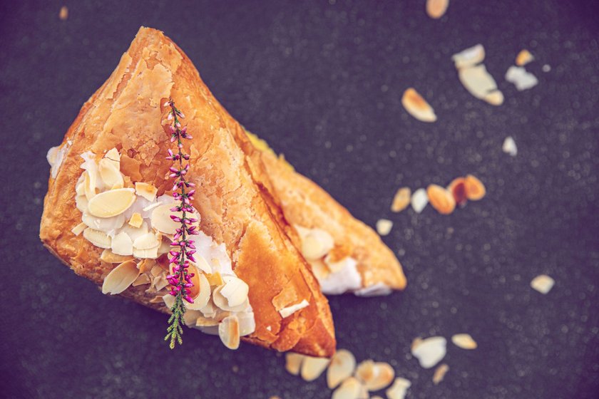 almond triangle cake cream puff pastry sweet dessert delicious healthy eating cooking appetizer meal food snack on the table copy space food background rustic top view
