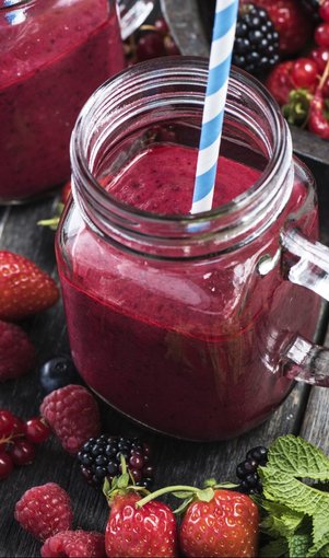 Summer berries smoothie in mason jar on rustic wooden table Summer berries smoothie in mason jar on rustic wooden table