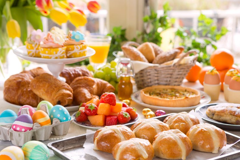 Breakfast or brunch table filled with all sorts of delicious delicatessen ready for an Easter meal.