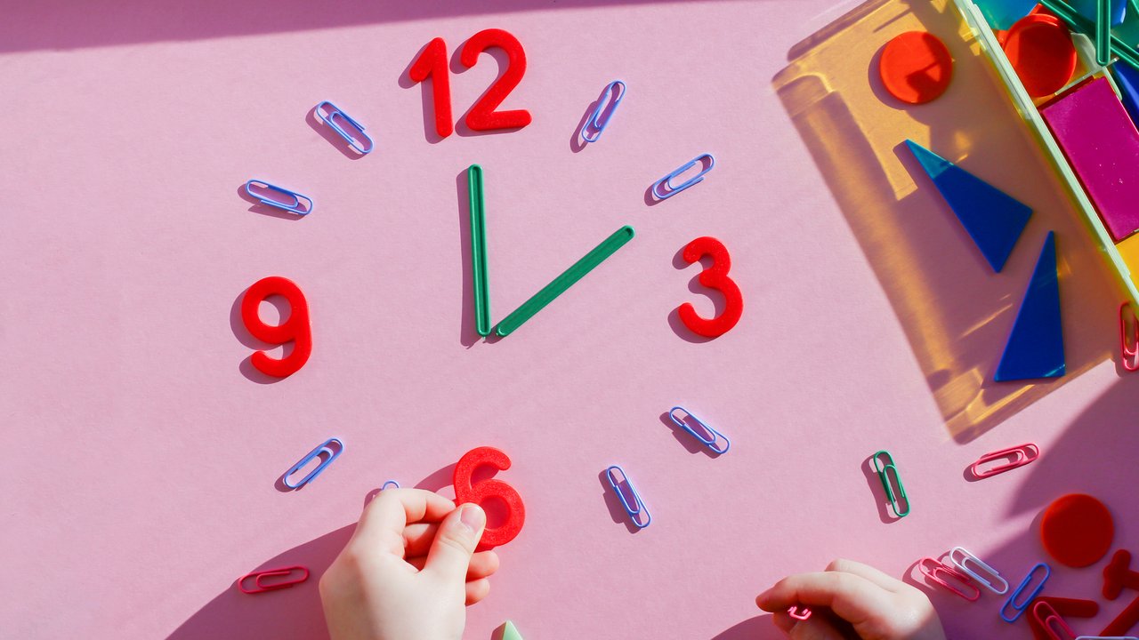 study the topic of hours with children. The watch is made of numbers, paper clips, and sticks from a children learning kit. early development, montessori, games with children