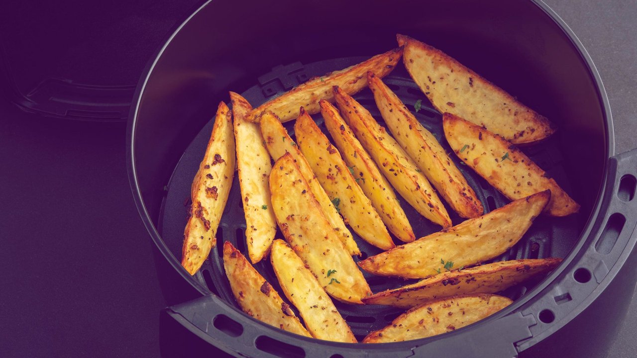 Homemade Roast Potatoes in an air fryer pot.potato wedges.