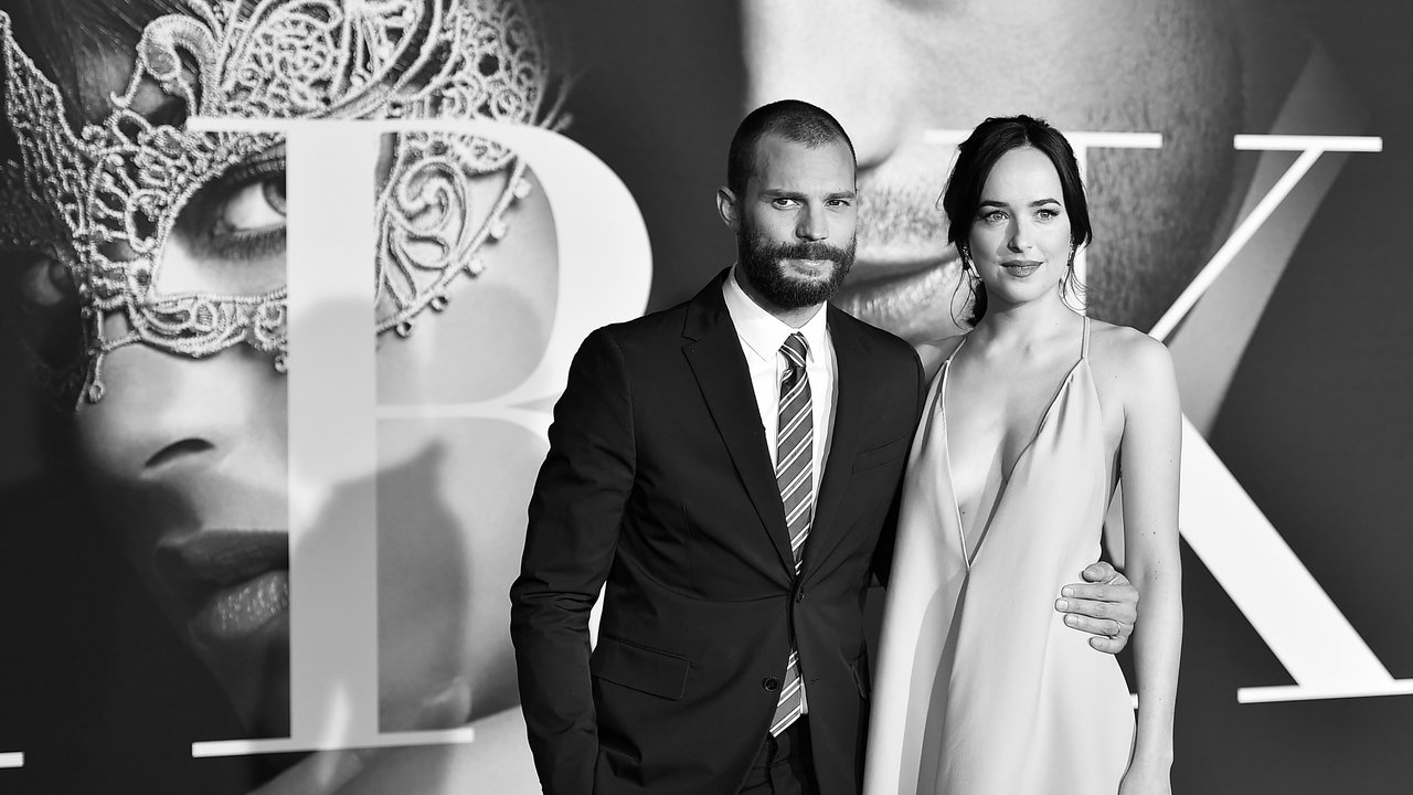 LOS ANGELES, CA - FEBRUARY 02: (EDITORS NOTE: Image has been converted to black and white.) Actors Jamie Dornan and Dakota Johnson attend the premiere of Universal Pictures' "Fifty Shades Darker" at The Theatre at Ace Hotel on February 2, 2017 in Los Angeles, California.  (Photo by Alberto E. Rodriguez/Getty Images)