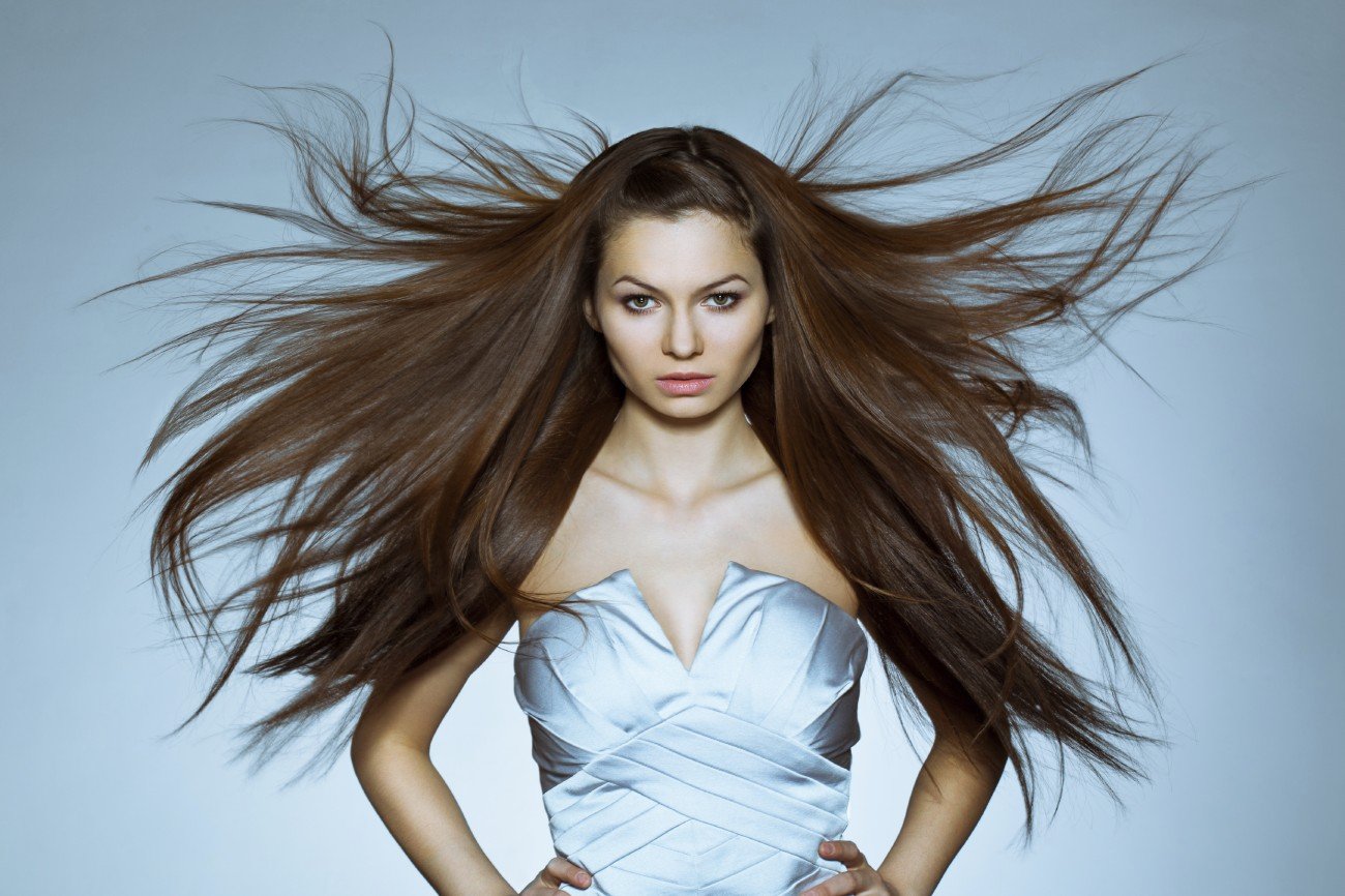 studio portrait of woman with flying hair studio portrait of woman with flying hair