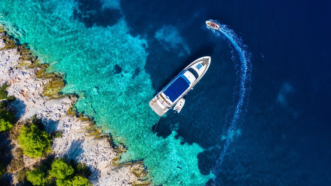 Mediterranean sea. View on marina from drone. Aerial view of floating boat on blue sea at sunny day. Travel and vacation image. Blue sea background. Luxury lifestyle.