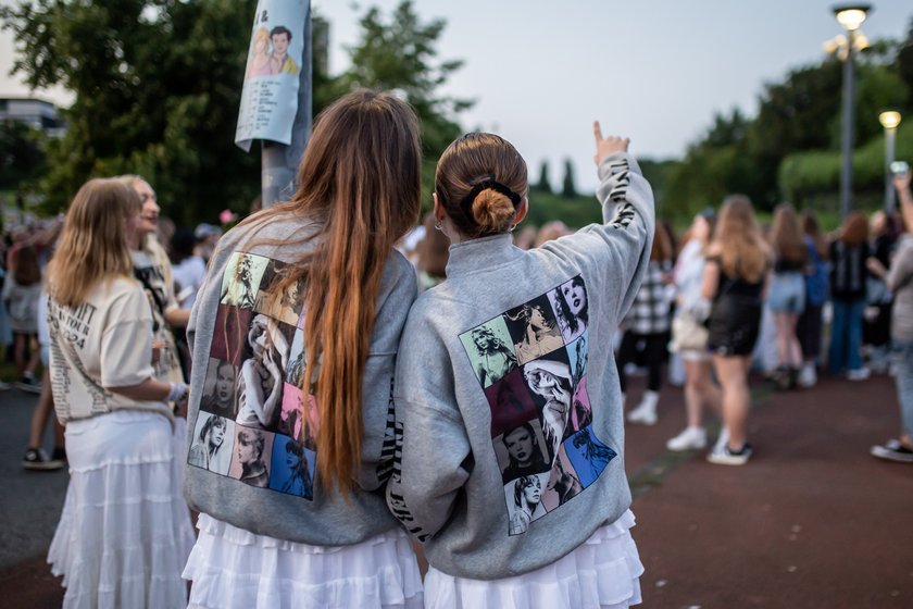 GELSENKIRCHEN, GERMANY - JULY 17: Taylor Swift fans without tickets gather in front of the Veltins Arena during the pop singer's concert on July 17, 2024 in Gelsenkirchen, Germany. In addition to the tens of thousands of fans arriving with tickets for the show, city authorities are also expecting possibly thousands more without tickets and has created fan hubs across the city. (Photo by Hesham Elsherif/Getty Images)