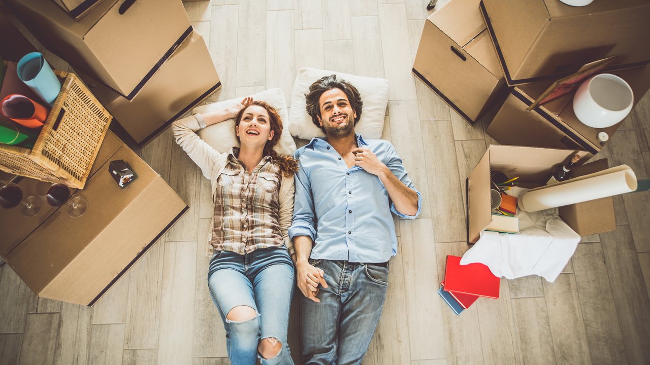 Young couple moving in into new apartment