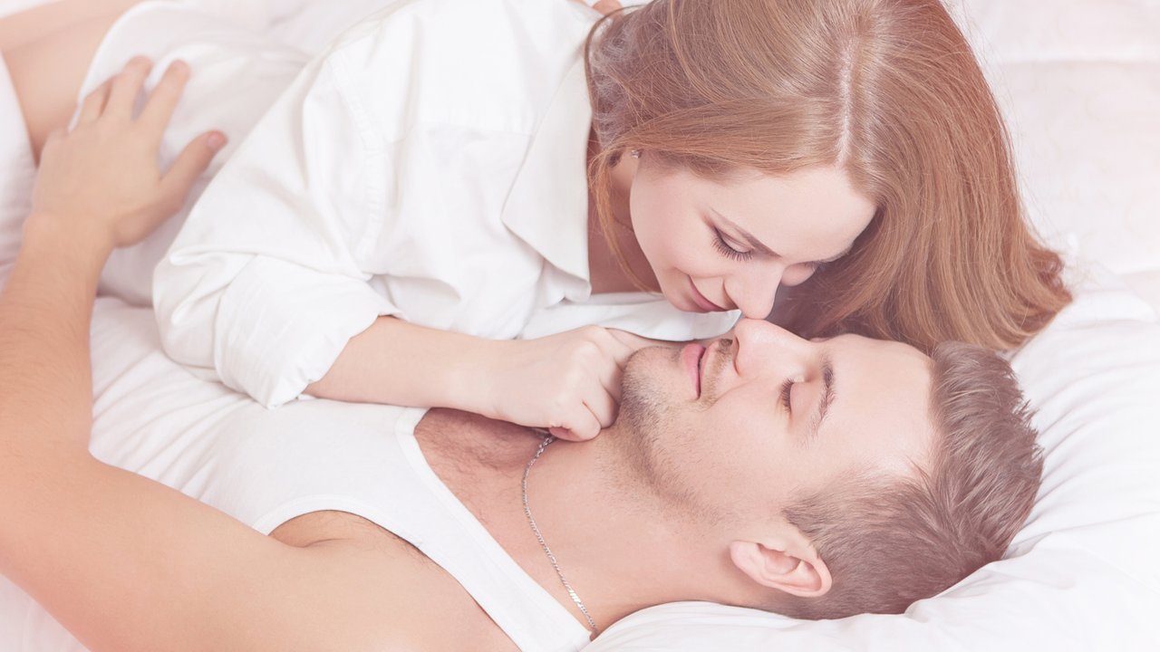 Sexual scene of gentle and affectionate young couple in the bedroom