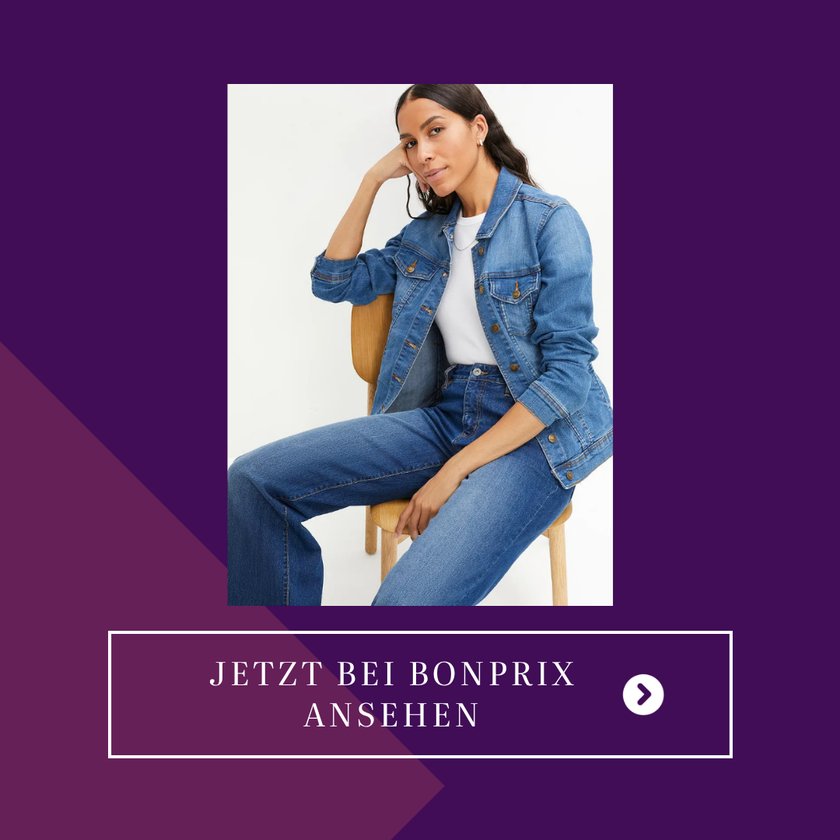 Eine&#x20;Frau&#x20;tr&#x00E4;gt&#x20;eine&#x20;klassische&#x20;Basic-Jeansjacke&#x20;in&#x20;einem&#x20;Blauton