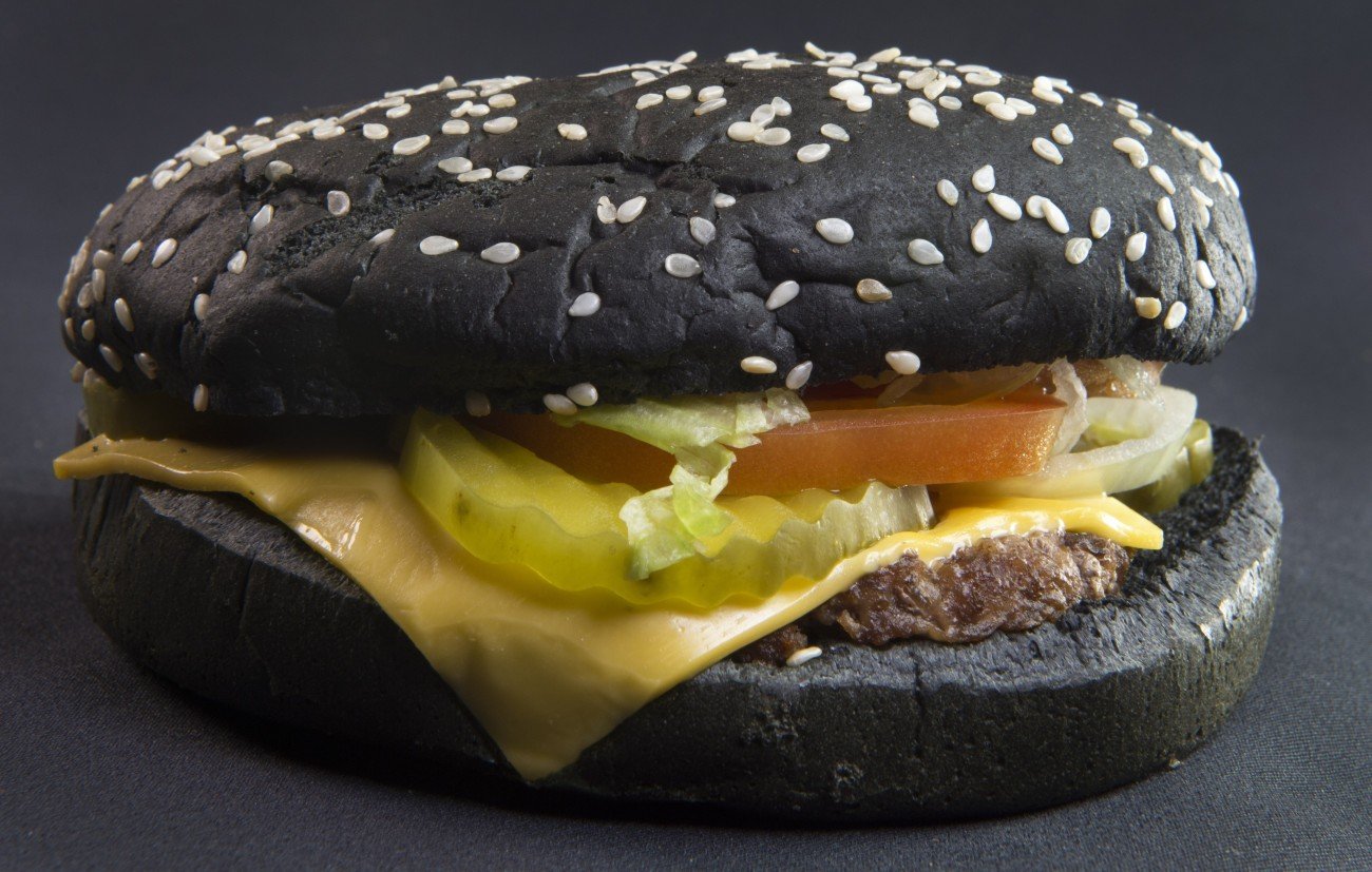 Recently released Burger King Halloween Whopper is seen on October 5, 2015, in Centreville, Virginia.  The burger, inspired by the Black Burger in Japan, is made with A-1 Steak sauce and food coloring, with a pitched-black bun covered with Sesame seeds. It has a suggested US retail price starting at $4.99 (USD).             AFP PHOTO/PAUL J. RICHARDS        (Photo credit should read PAUL J. RICHARDS/AFP/Getty Images)