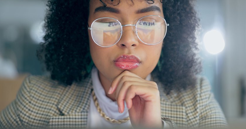 Thinking, glasses and business woman in night office reading, planning or brainstorming. Questions, face and female entrepreneur online at startup company for problem solving, research or analysis