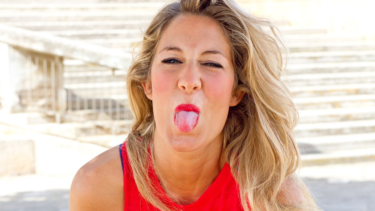 Blond woman sticking tongue out