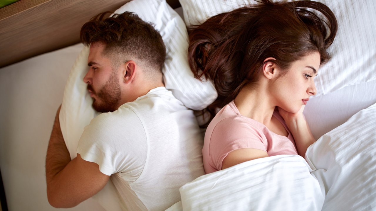 Couple with problems in relationship in bed