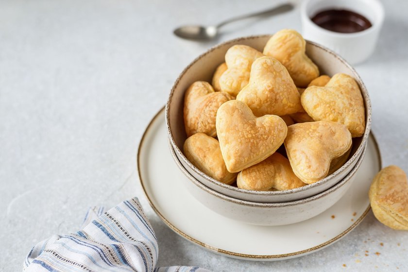 Heart shaped puff pastry snack with chocolate dip, sweet romantic breakfast