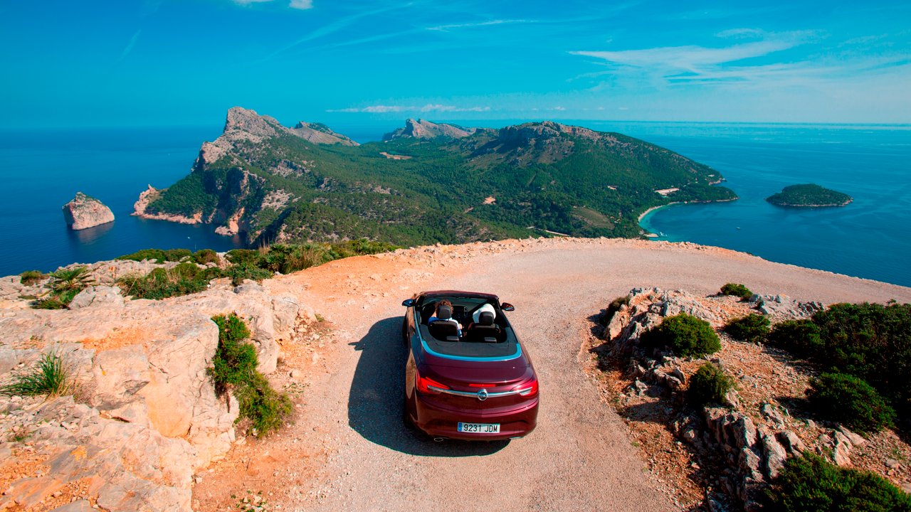 Sunny Cars convertible on road overlooking Cap de Formentor peninsula, Mallorca, Balearic Islands, Spain