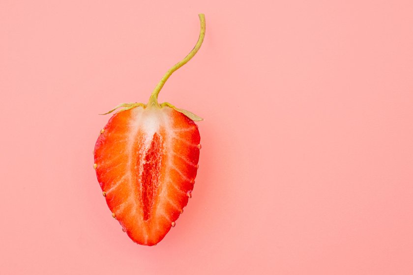 Close-up of strawberry slice with form as female vagina, creativity concept picture