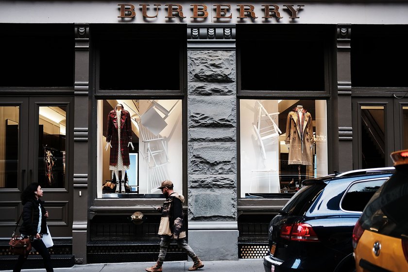 NEW YORK, NY - NOVEMBER 09: Pedestrians walk by a Burberry store on November 9, 2017 in New York City. Shares for the heritage English fashion brand fell on Thursday to their lowest level in five years on news that the brand looks to become an exclusive luxury business. (Photo by Spencer Platt/Getty Images)