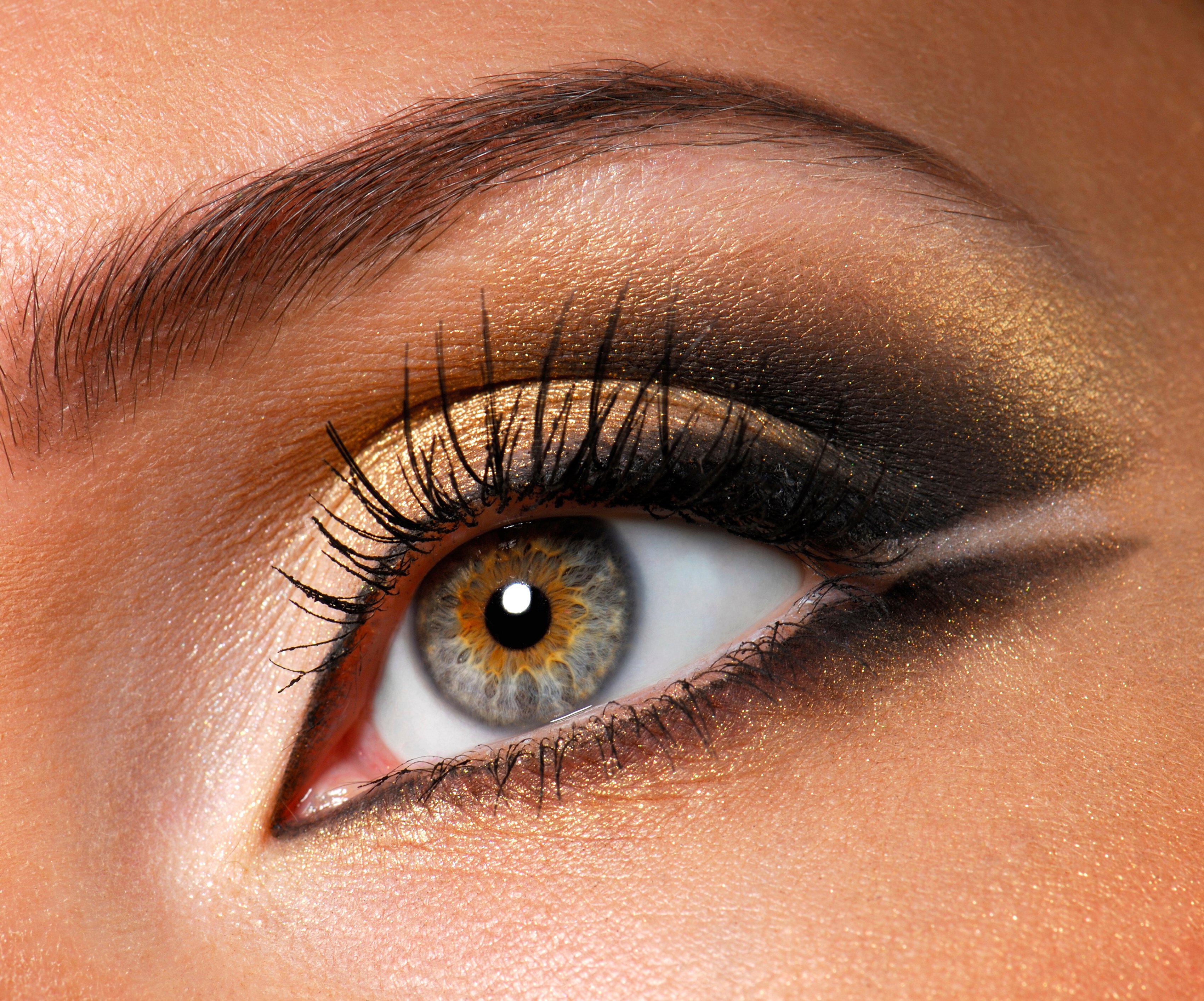 Modern style of golden-brown make-up. Beautiful woman eyes