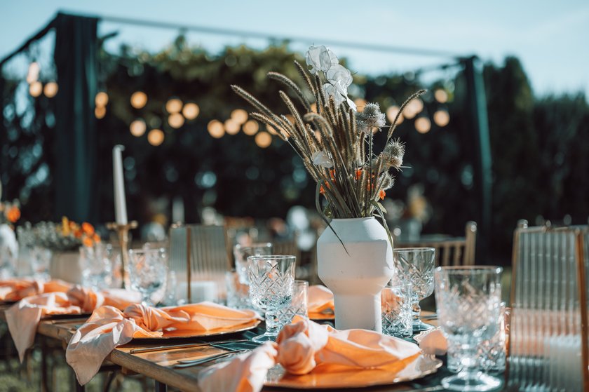 Beautiful wedding table decoration and setting in rustic / village style.