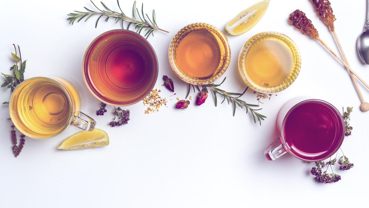 Herbal tea collection prepared in glasses on white background