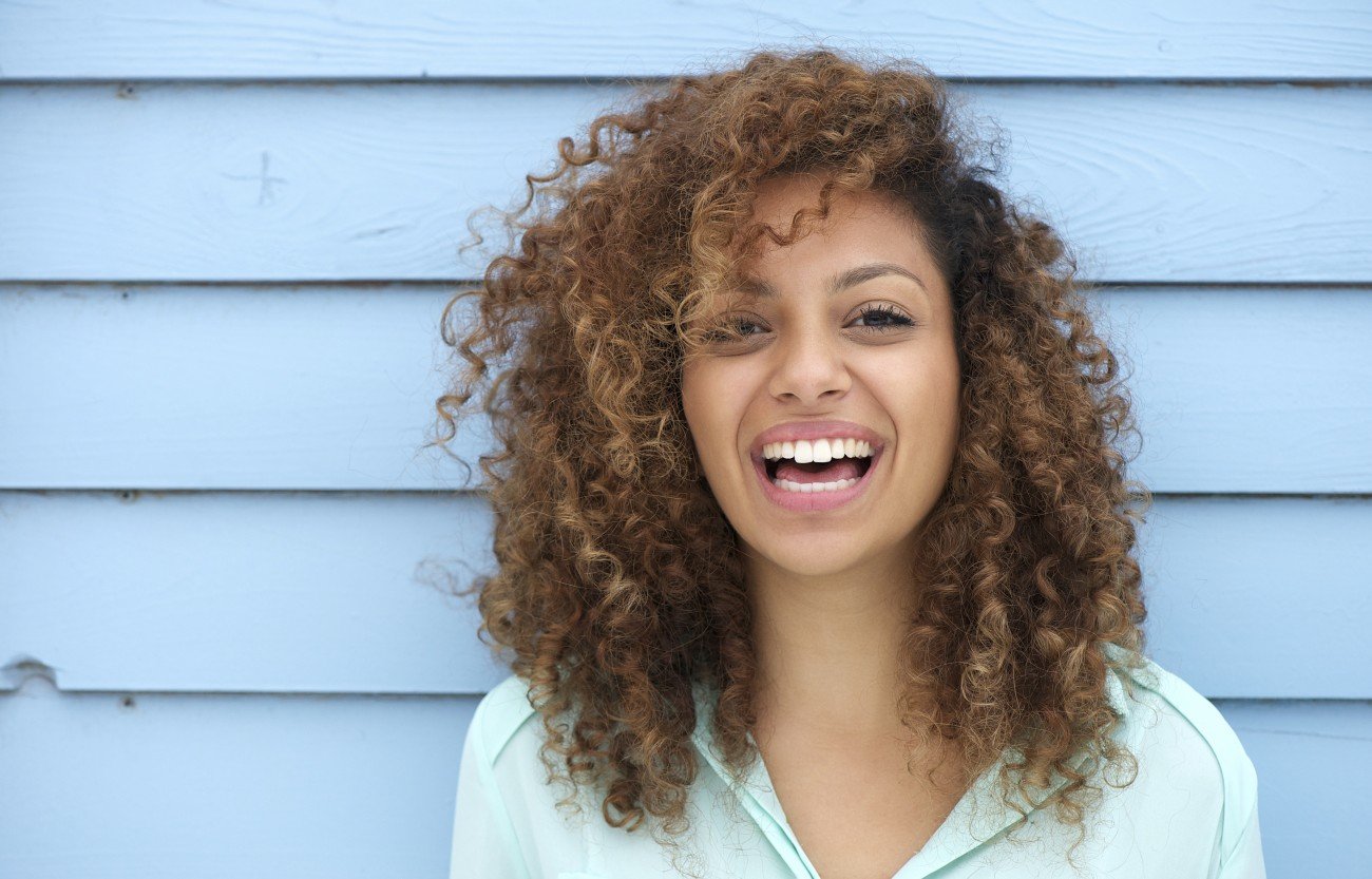 Portrait of a cheerful young african woman smiling Portrait of a cheerful young african woman smiling