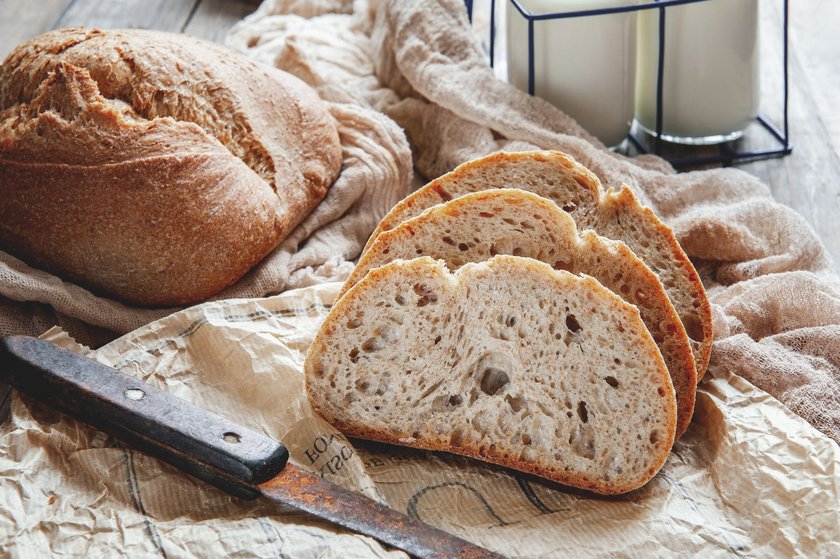 Delicious homemade sourdough rye bread on a plate and milk. Homemade baking.