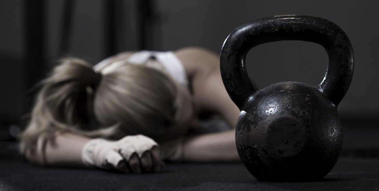 Portrait of drained girl after hard crossfit training with kettlebell Portrait of drained girl after hard crossfit training with kettlebell