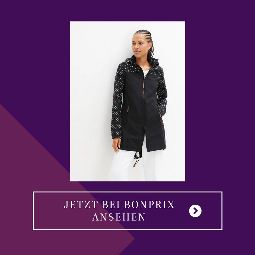 Eine Frau trägt eine lange Softshelljacke