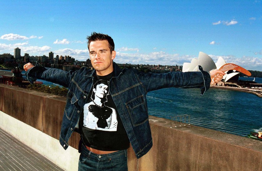 RECORD DATE NOT STATED  In Sydney Australia ROBBIE WILLIAMS In Sydney Australia Ref: IJCD sydney opera house, boomerang, denim jacket, david bowie t-shirt, arms spread, half length, half-length Sydney Australia Copyright: xIanxJennings/CapitalxPicturesx