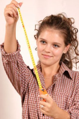 Modedesign Studentin mit blonden hochgesteckten Locken h�¤lt ein Ma��band Modedesign Studentin mit blonden hochgesteckten Locken h�¤lt ein Ma��band