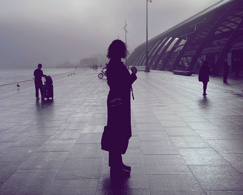 Frau steht an einer Promenade