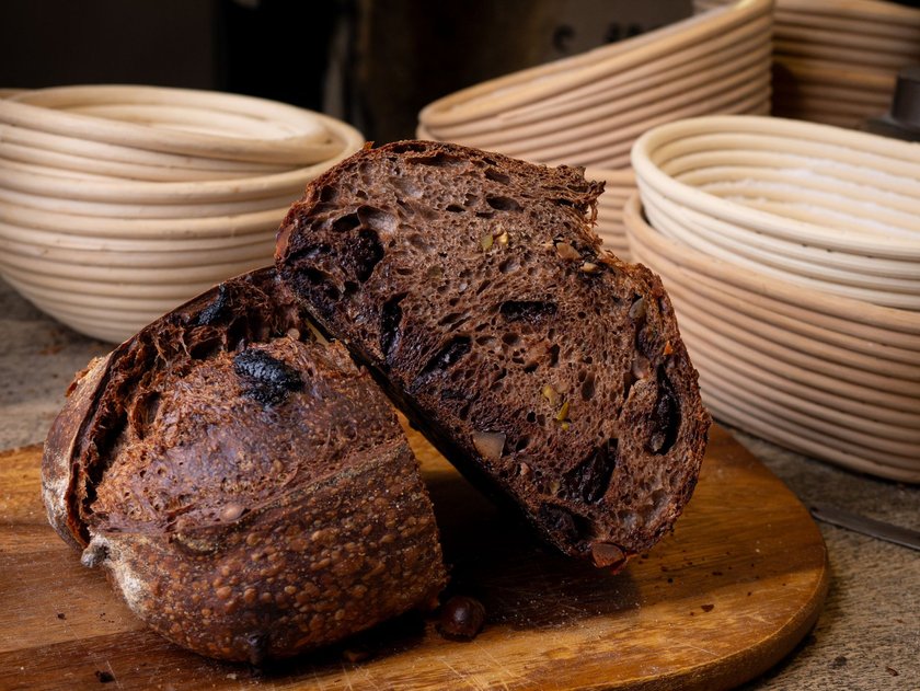 Freshly Baked Artisan Chocolate Sourdough Bread on Wooden Table.