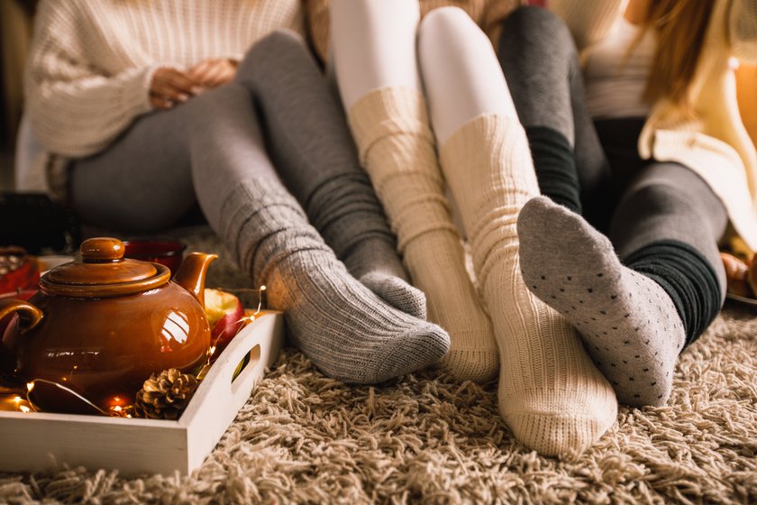 drei Frauen, die in Socken Herbsttag genießen